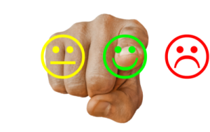 Fist bump with neutral, positive and negative smiley faces indicating customer sentiment