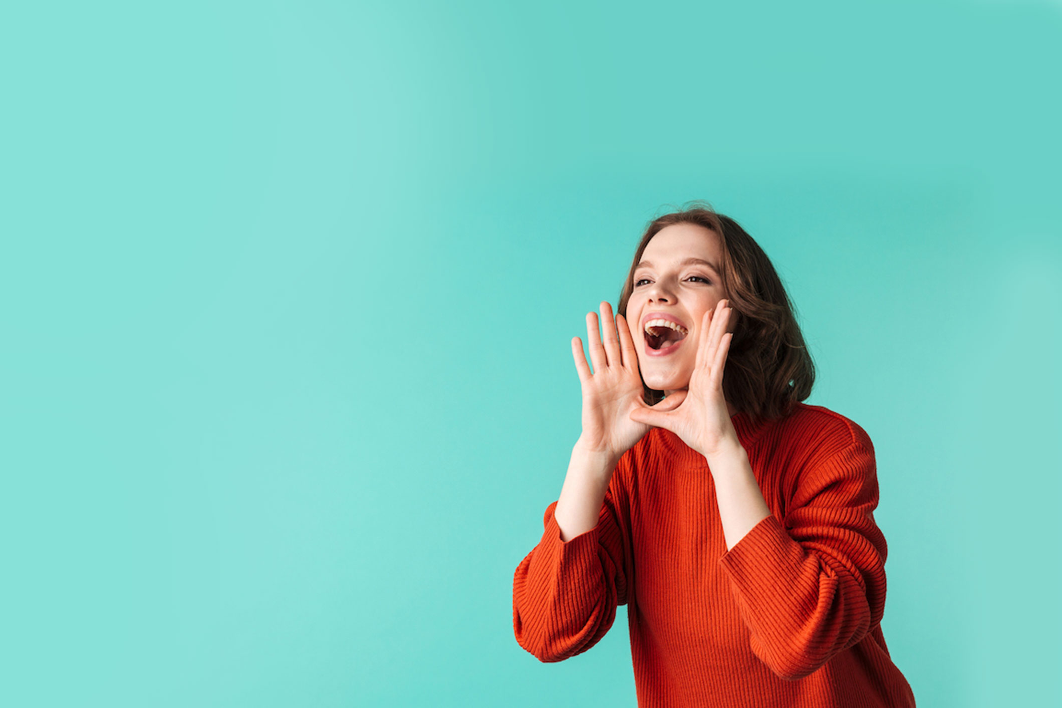 happy woman with announcement standing isolated over blue background looking aside.