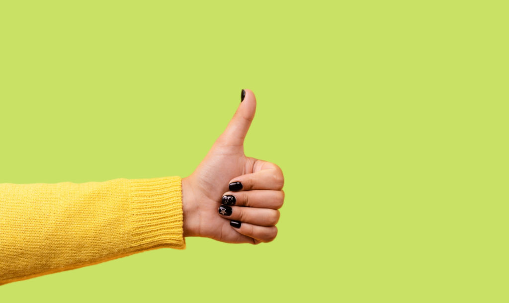 thumbs up against lime green background