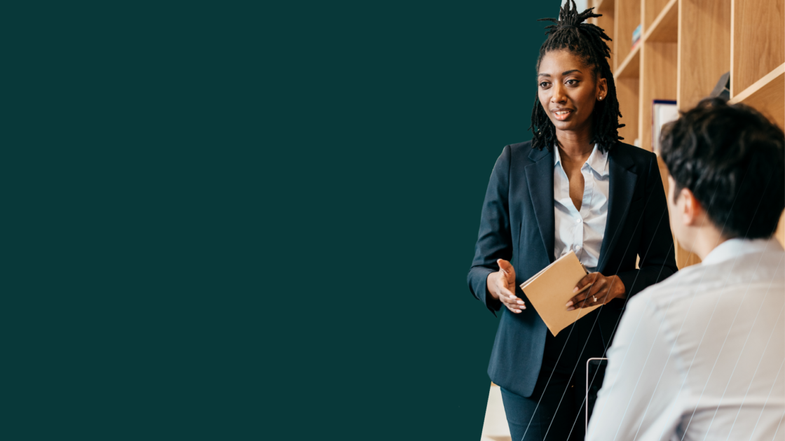 Consultant presenting ideas and discussing strategy with a client, representing how to manage client expectations through clear communication and collaboration.