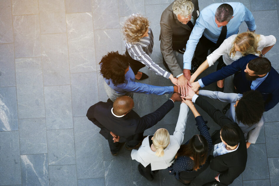 people with hands in the center of a circle for product marketing and product management