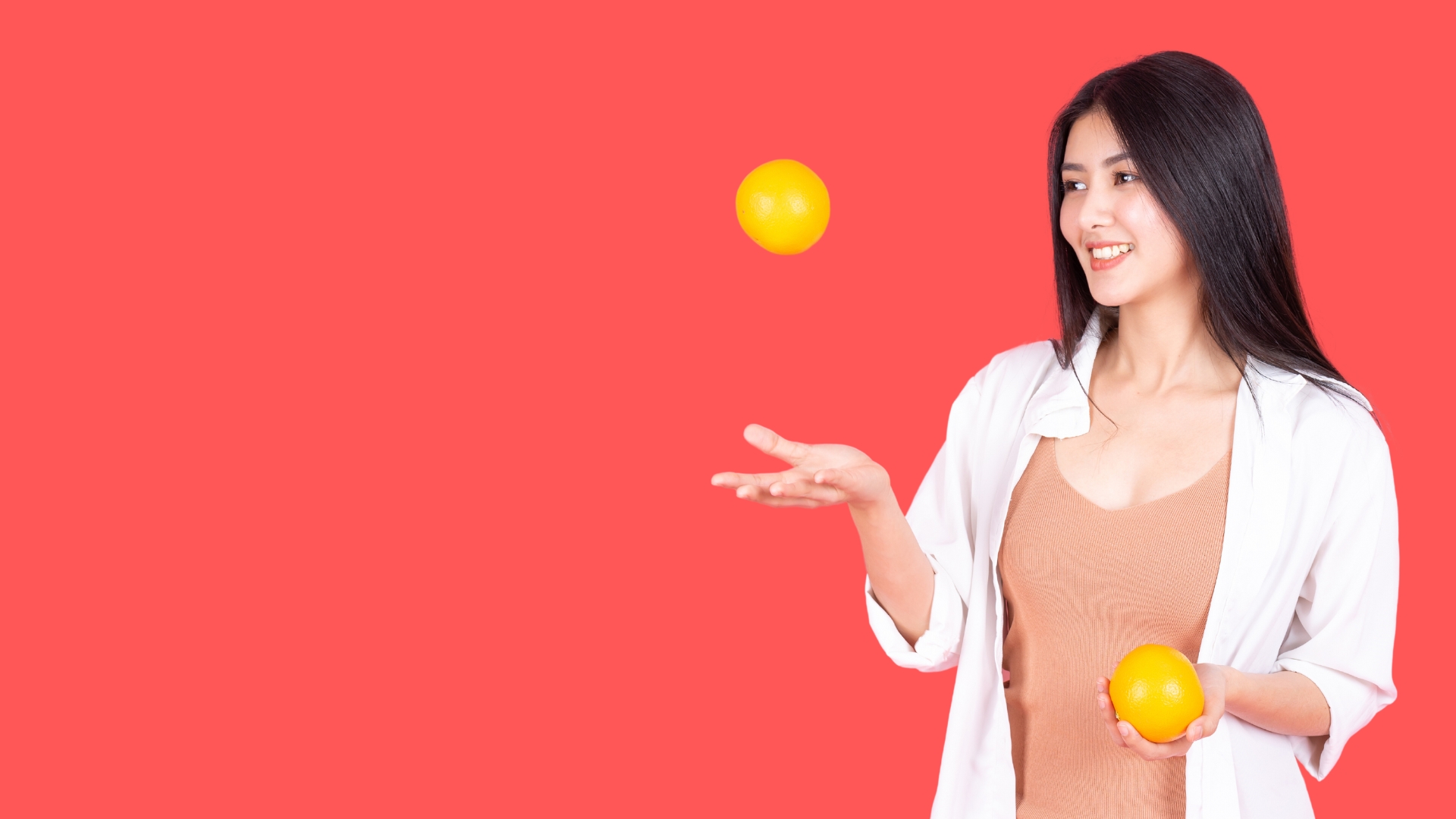 woman juggling oranges on red background for PMM priorities
