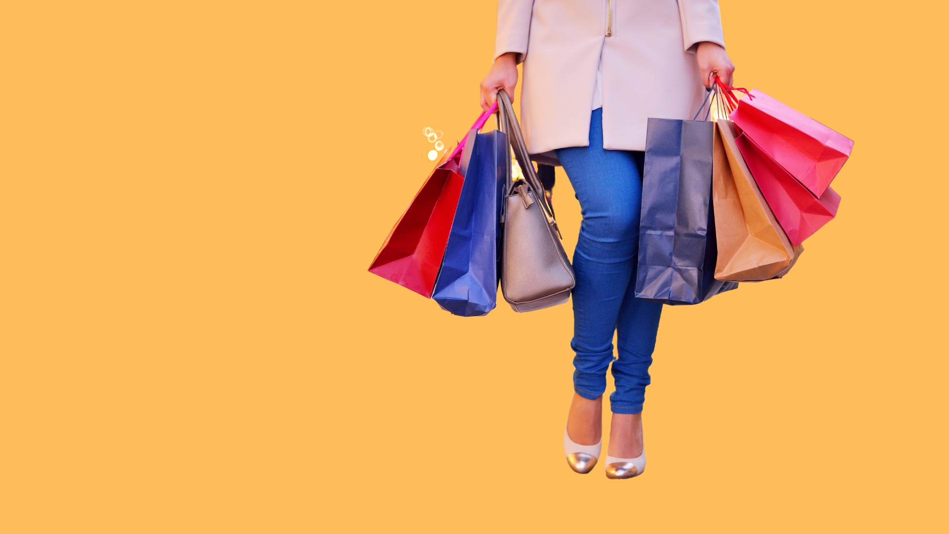 woman with shopping bags on orange background for quick EOY ROI