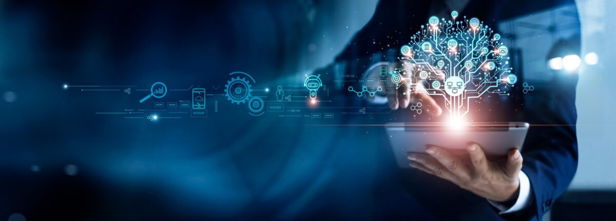 Business professional holding a tablet with a glowing digital AI network overlay, representing AI-driven business operations and digital transformation.