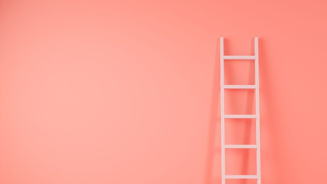 ladder against a pink bakcground