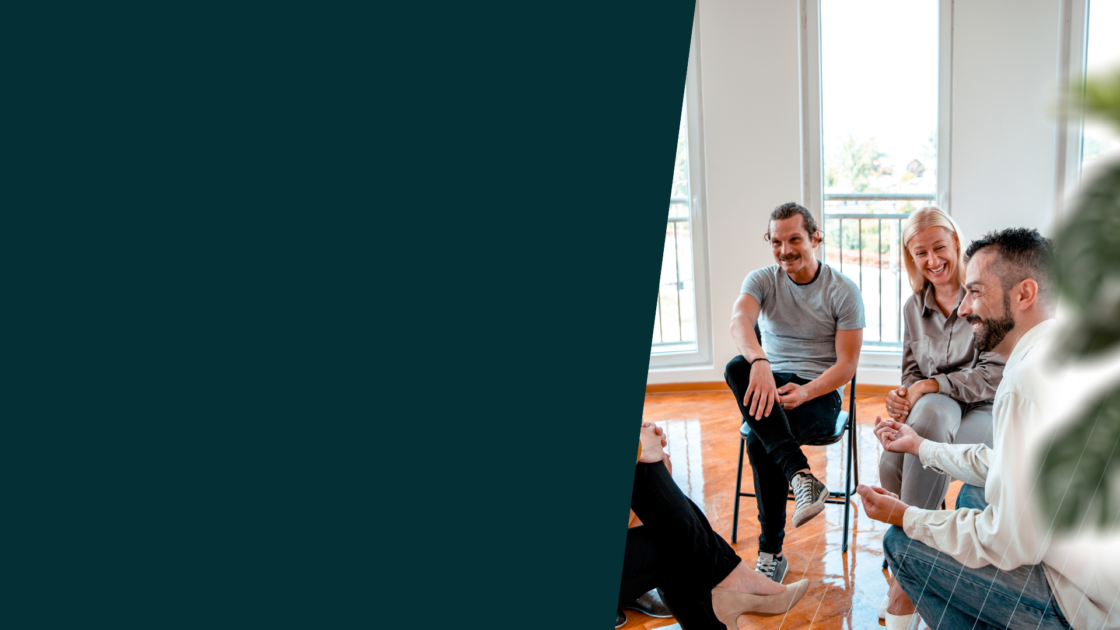 Marketing professionals collaborating in a group discussion, representing how teams apply AI in marketing to improve strategy, alignment, and decision-making.