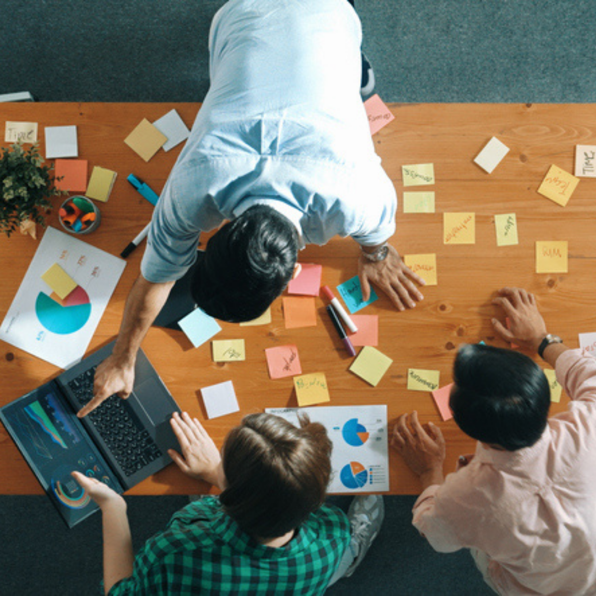 Team collaborating on marketing strategy and data analysis, representing fractional leadership in action