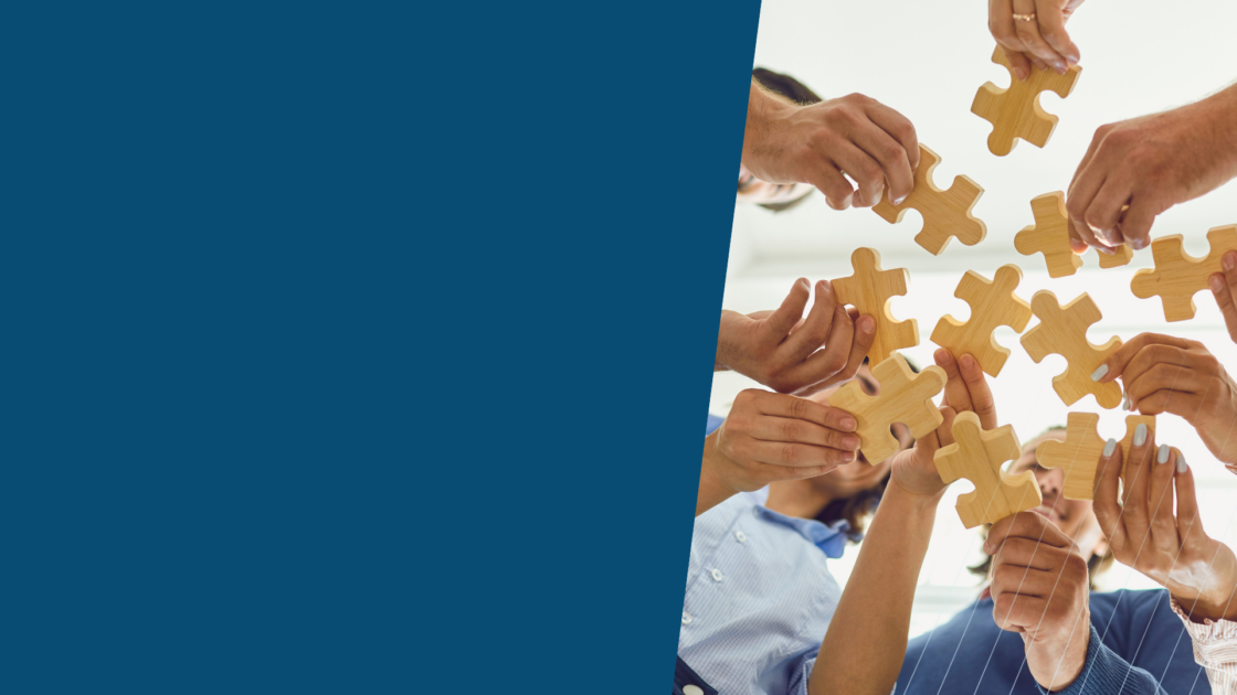Team collaborating to fit puzzle pieces together, symbolizing the alignment challenges that cause many channel partner programs to stall.