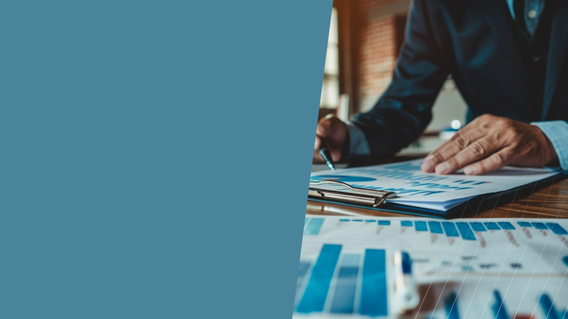 Business professional reviewing charts and documents, representing a sales enablement system focused on driving adoption, aligning teams, and ensuring sales assets are actively used—not just created.
