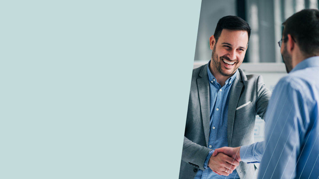 Two business professionals shaking hands during a meeting, representing GTM positioning alignment, product marketing collaboration, strategic market positioning, and partnership-driven go-to-market planning.